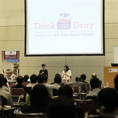 Speakers on stage discussing the value of U.S. dairy proteins